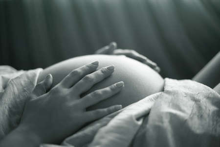 The pregnant woman on the ninth month. The child will be born one of these daysの写真素材