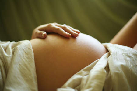 The pregnant woman on the ninth month. The child will be born one of these daysの写真素材