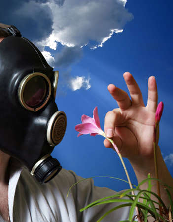 The man in a gas mask with flowersの写真素材