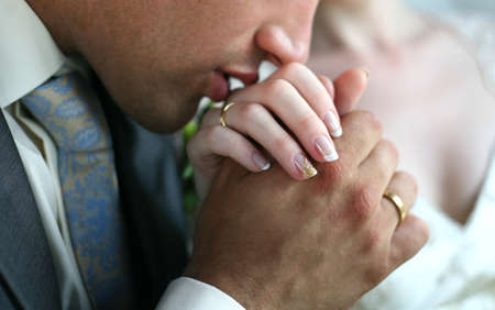 The groom kisses a hand to the brideの写真素材