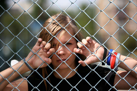 The young girl behind a lattice