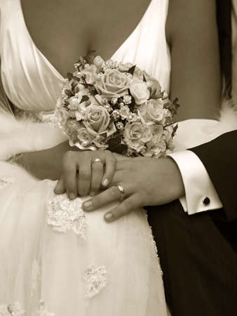 Hand of the groom and the bride with wedding ringsの写真素材