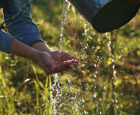 The man washes hands with transparent waterの写真素材