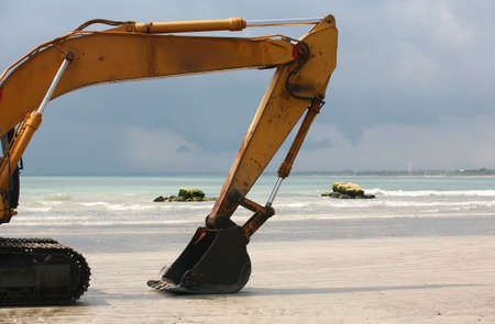 A view of a big bulldozer on coastlineの写真素材
