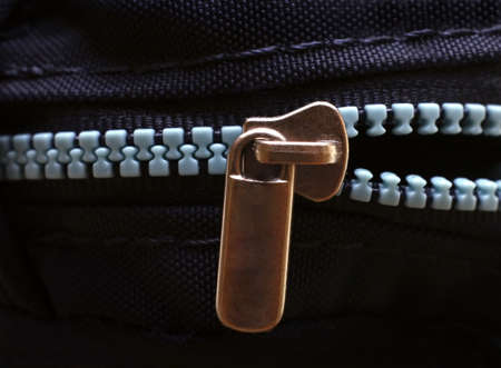 The zipper of a black bag on a black backgroundの写真素材