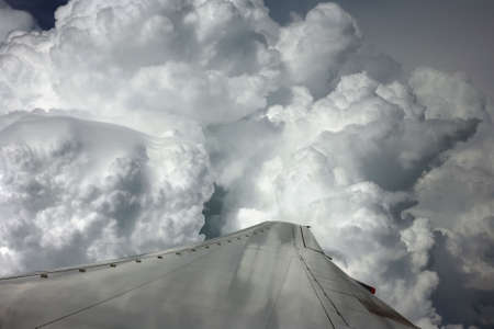Wing of the plane on a background of cloudsの写真素材