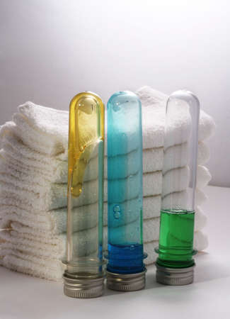 White towels and three bottles with shampooの写真素材