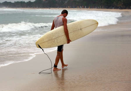 Lonely the man-surfer on a coastline. Bali