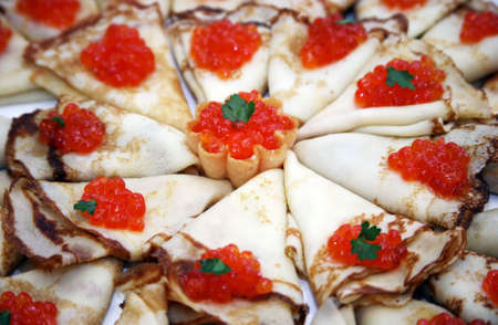 Pile of pancakes and caviar on a celebratory tableの写真素材