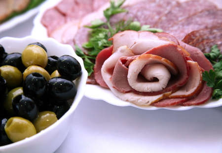 Olives and sausage on a celebratory tableの写真素材