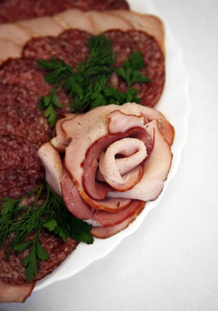 The cut sausage on a white plateの写真素材