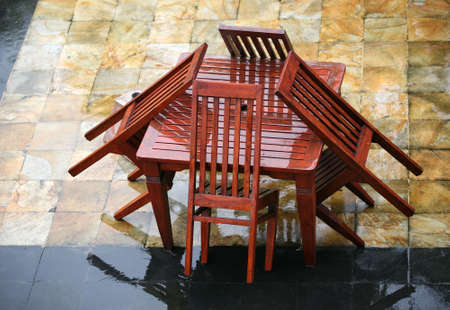 Table and chairs wet from a rainの写真素材