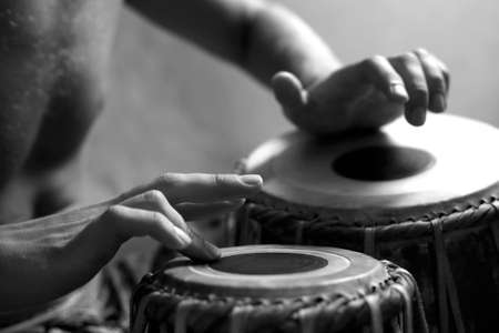 Man playing the djembe (nigerian drum) in studioの写真素材