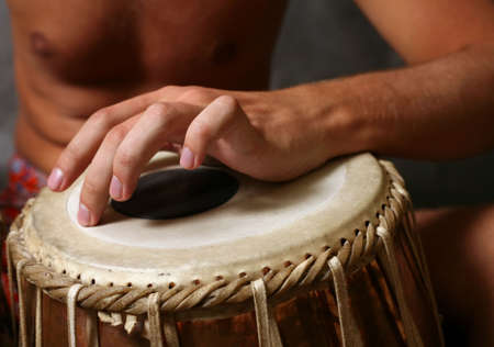 Man playing the djembe (nigerian drum) in studioの写真素材