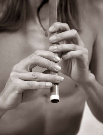 Hands of the musician playing on his wind instrument の写真素材