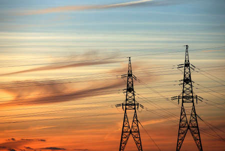 High voltage tower on a background of the red sky