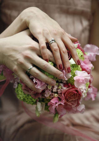Hand of the groom and the bride with wedding ringsの写真素材