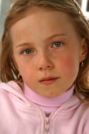 Face of a young girl with fair skin and freckles.の写真素材