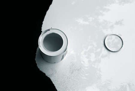 White paint is flowing down of black backgroundの写真素材