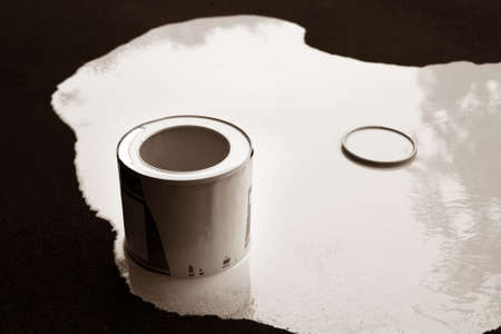 White paint is flowing down of black backgroundの写真素材