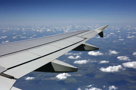 Wing of the plane on a background of sky