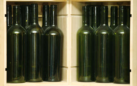 Empty green bottles in a wooden boxの写真素材