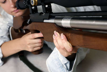 The girl with a gun in studioの写真素材