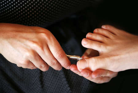 The pedicurist makes a pedicure to the womanの写真素材