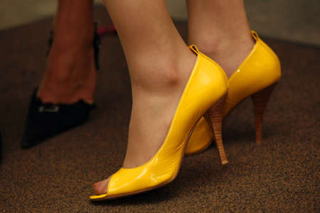 Legs of the girl in yellow shoesの写真素材
