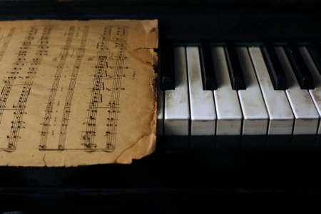 The keyboard of the piano and old notesの写真素材