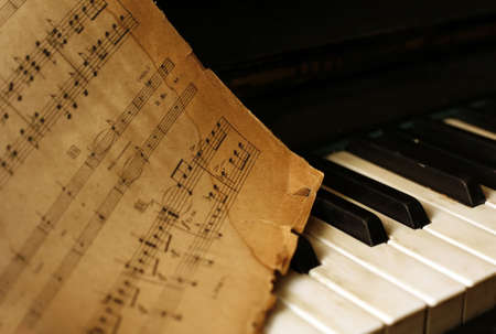 The keyboard of the piano and old notesの写真素材