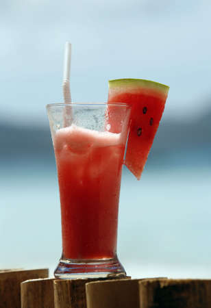 Glass with water-melon juice on a background of the seaの写真素材