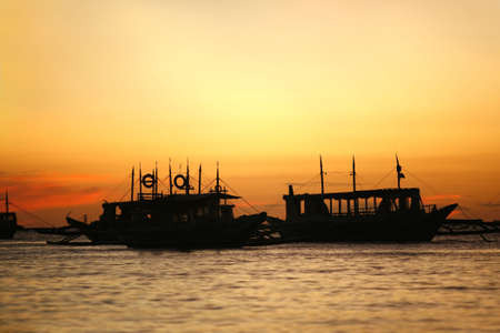 Drifting boat on a sunset. Coast of the Pacific ocean. Island Boracayの写真素材
