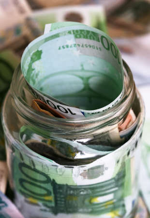 Banknotes in glass bank on a background of moneyの写真素材