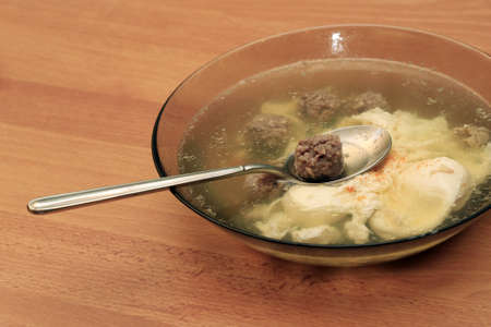 Transparent broth with egg and meat ballsの写真素材