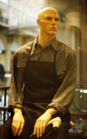 Dummy in working clothes in a show-window of a boutiqueの写真素材