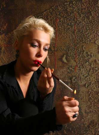 The blonde with a cigarette in studioの写真素材