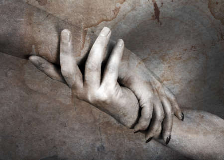 Hands of the man and the woman on a background of an old paperの写真素材