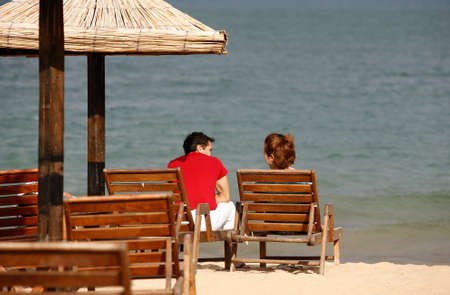 Pair at coast. Bulgaria. Gold sandの写真素材