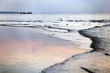 Beach in the winter period, on a background a vesselの写真素材