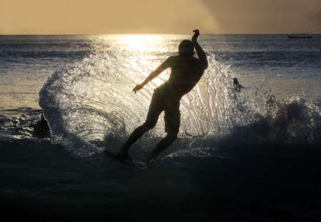 Young men - the surfer in ocean. Bali. Indonesia