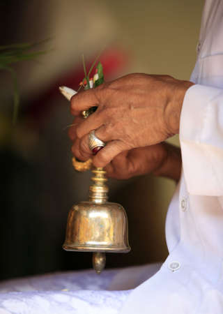 Ceremonial bell in hands of the priestの写真素材