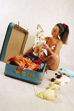 The girl in underwear with a suitcaseの写真素材