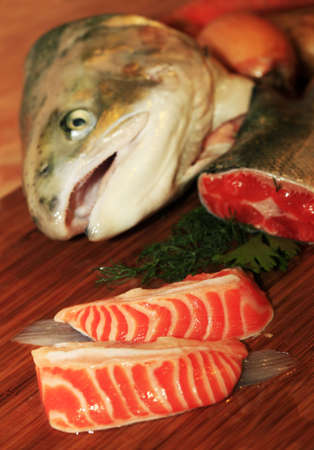 Fresh red salmon fish on wooden cooking desk