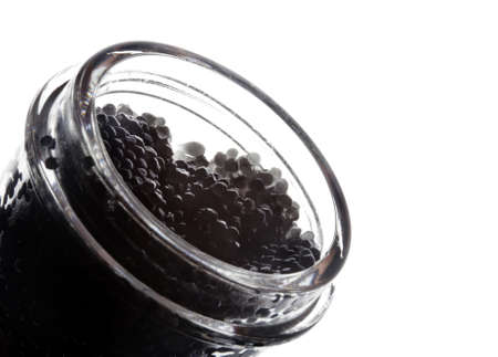 Black caviar in glass bank close-up