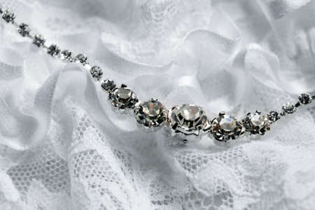 Wedding necklace on a background of a wedding garterの写真素材