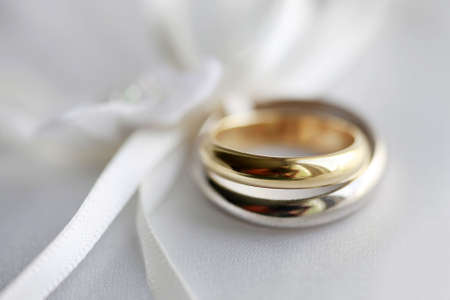 Wedding rings on a blue satiny fabric. Depth of fieldの写真素材