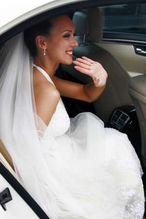The beautiful bride in the automobile
