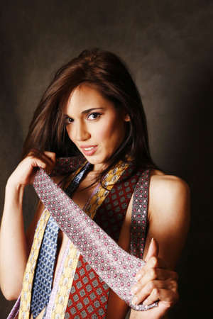 Portrait of the beautiful brunette with ties in studioの写真素材