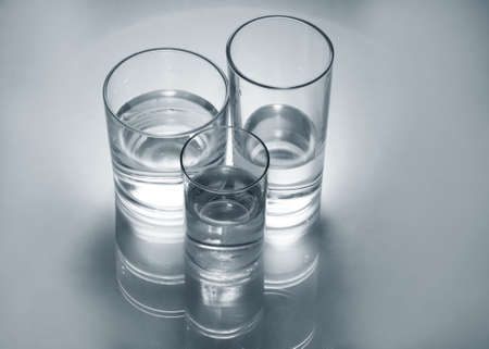 Three different glass glasses with waterの写真素材